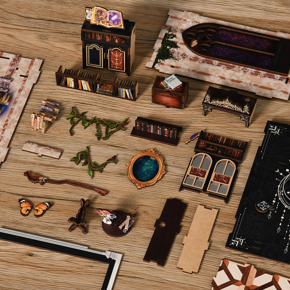 DIY miniature book nook kit parts laid out on wood board for assembly