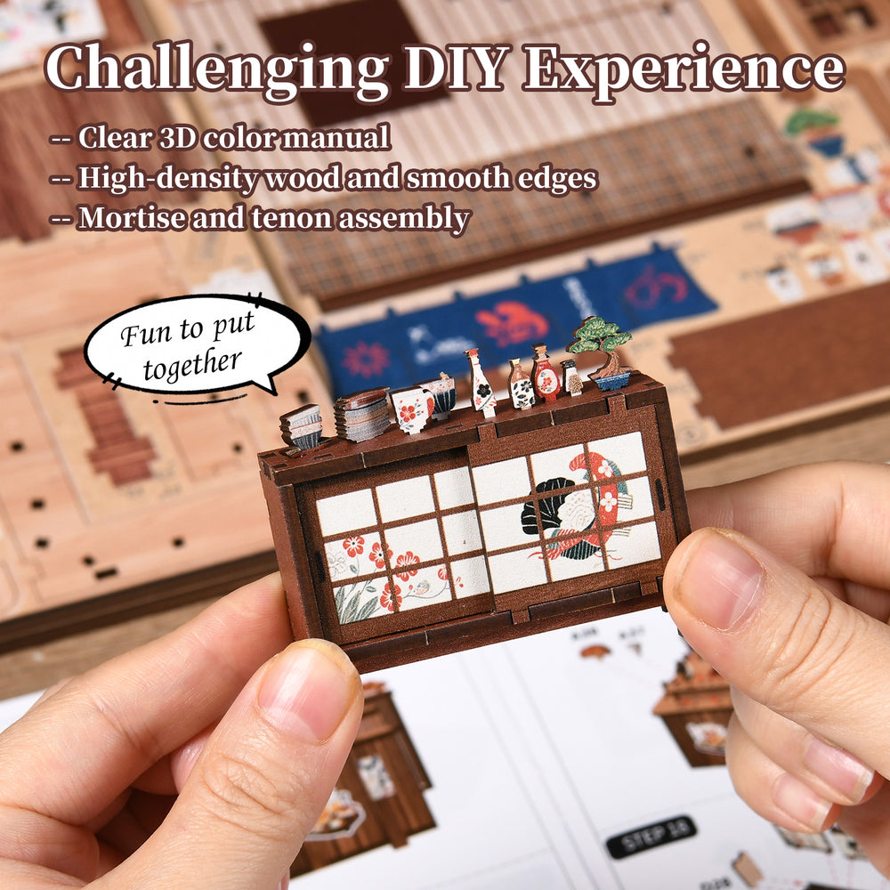 DIY miniature book nook kit with hands assembling a printed front panel