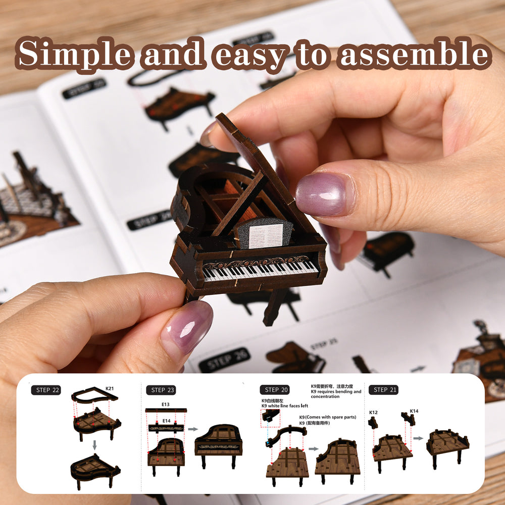 Miniature piano model kit being assembled by hands over an instruction sheet