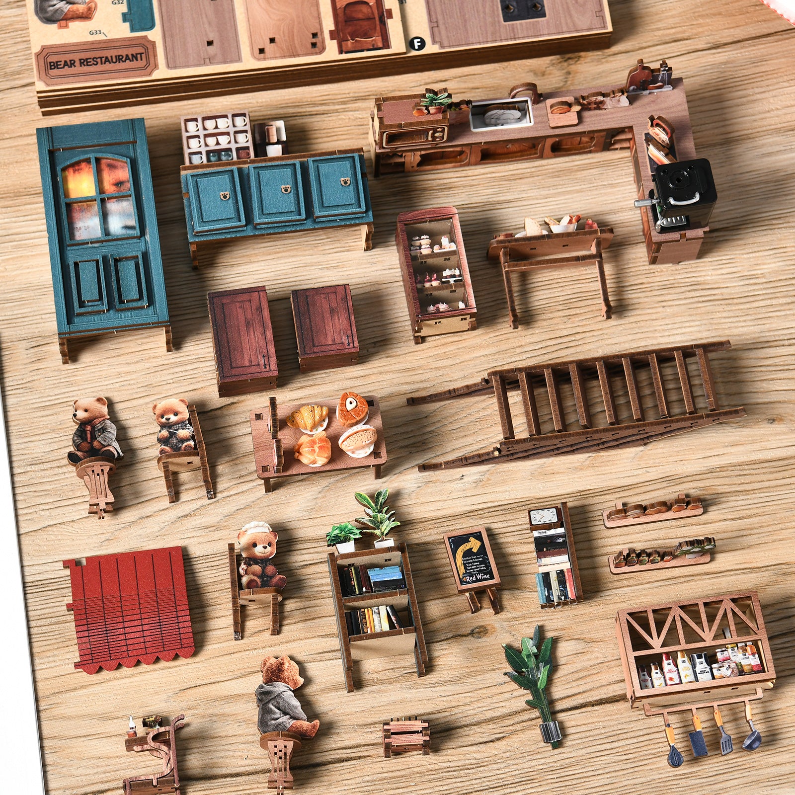 DIY mini house restaurant kit parts laid out on a tabletop, including furniture and figurines