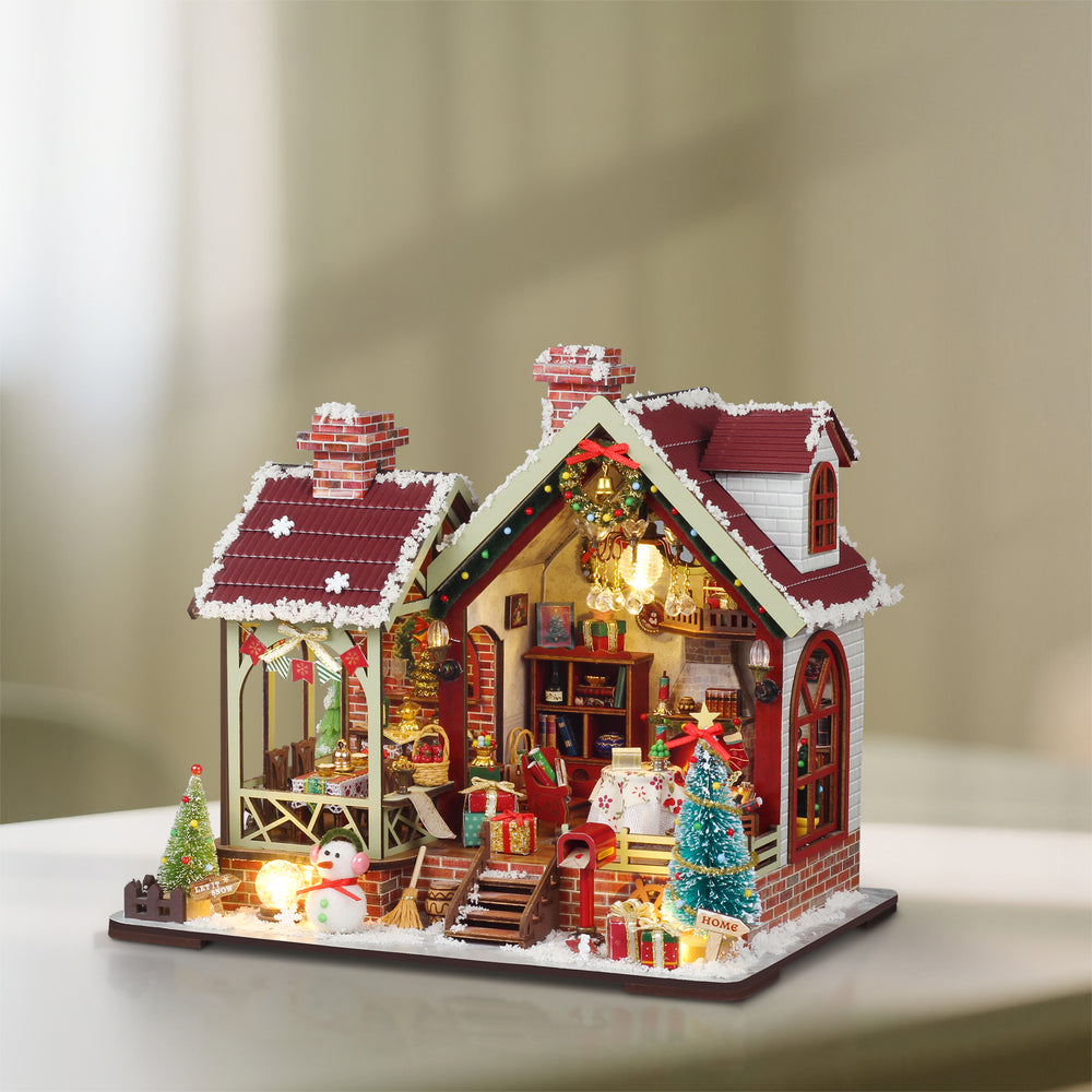 Cozy Christmas miniature dollhouse kit with lit interior, red roof, and snow trim