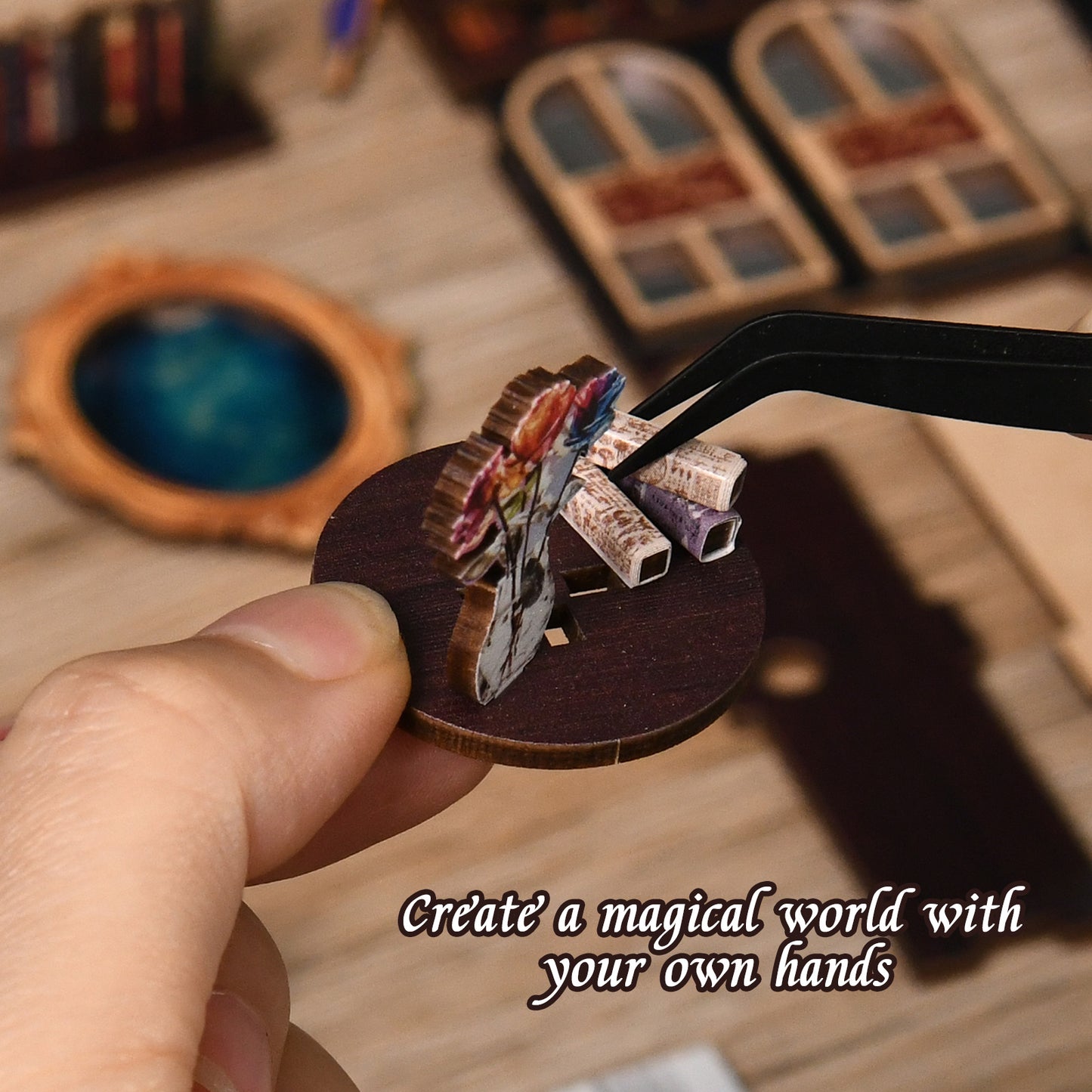 A hand is holding a small wooden object, which appears to be a miniature figurine or model, with a pair of tweezers or a small tool being used to manipulate it.