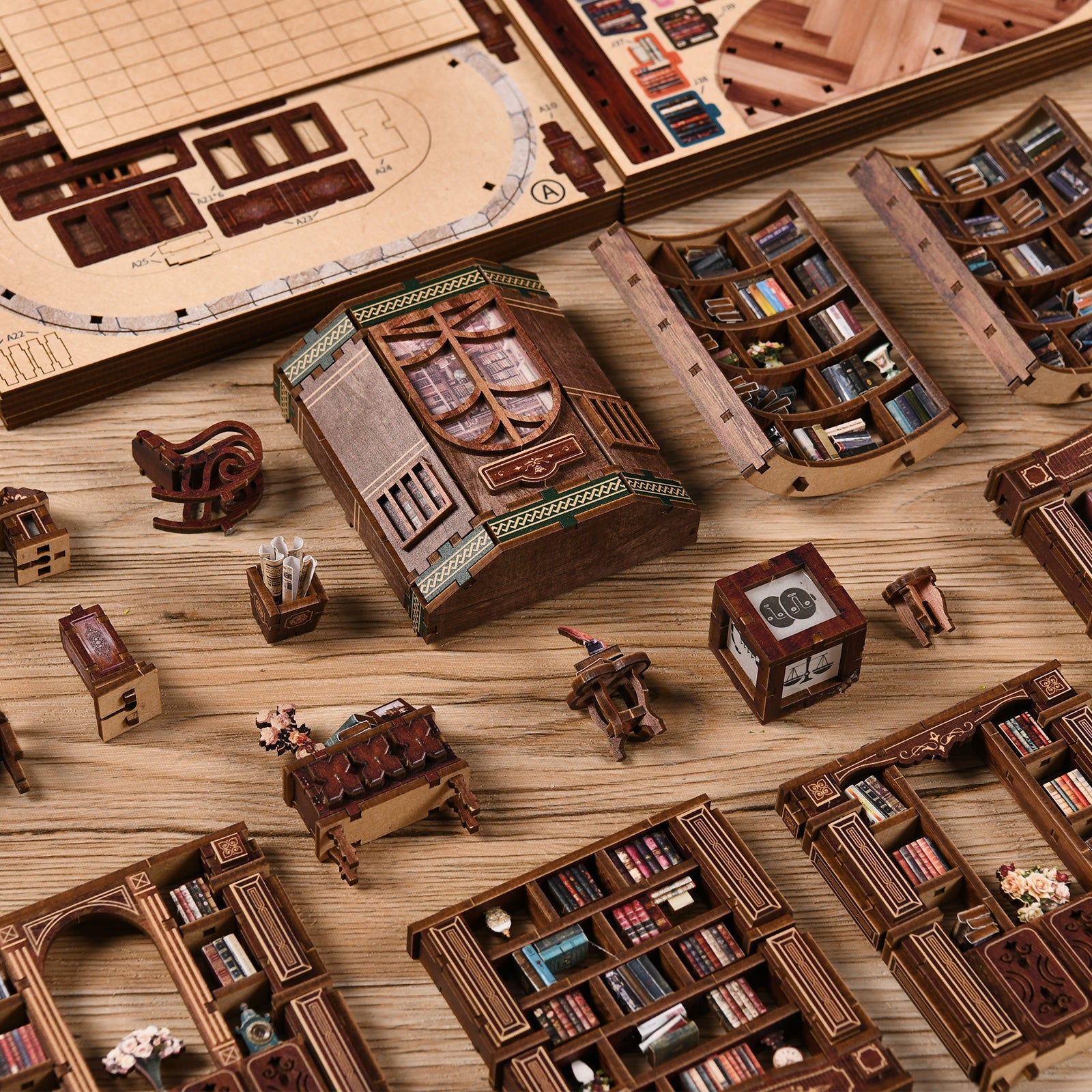 a collection of wooden toys and models, including miniature bookshelves, a rocking horse, and other small wooden objects, arranged on a wooden surface.