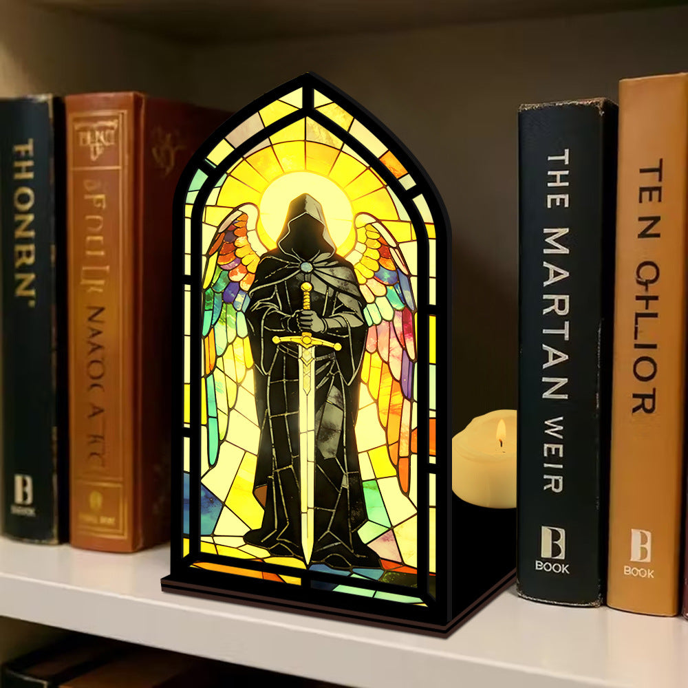Stained-glass arched book nook display with hooded knight figure and lit candle beside it