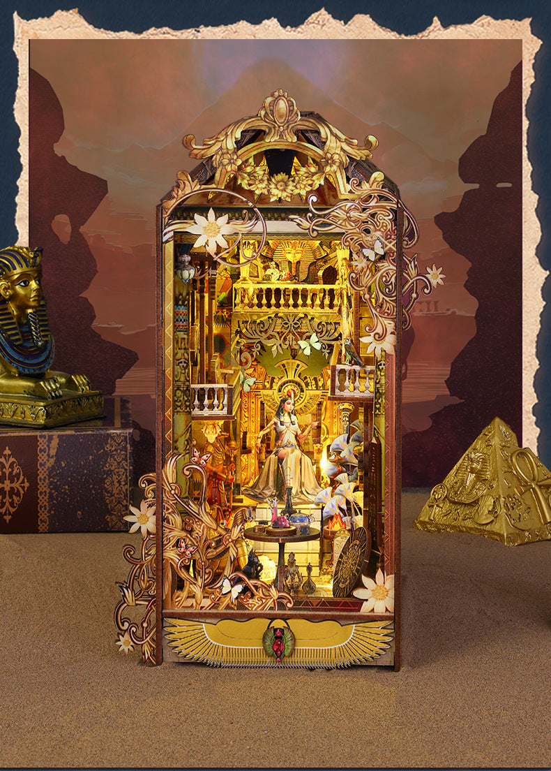 Ornate golden-brown wooden book nook miniature with open front and central figurines
