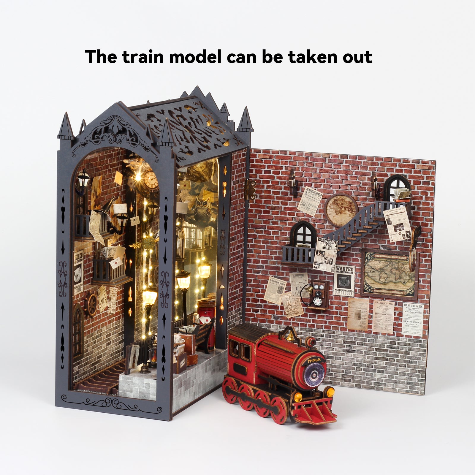 Miniature train book nook kit with open panels, brick backdrop, and red toy train