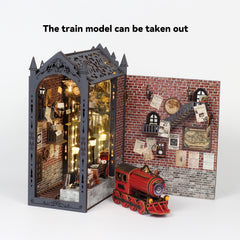 Miniature train book nook kit with open panels, brick backdrop, and red toy train