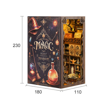 a book-like structure with a dark background and various decorative elements, including a witch's hat, a crescent moon, and a crescent star. The text "MAGIC at NIGHT" is prominently displayed on the front cover of the structure.