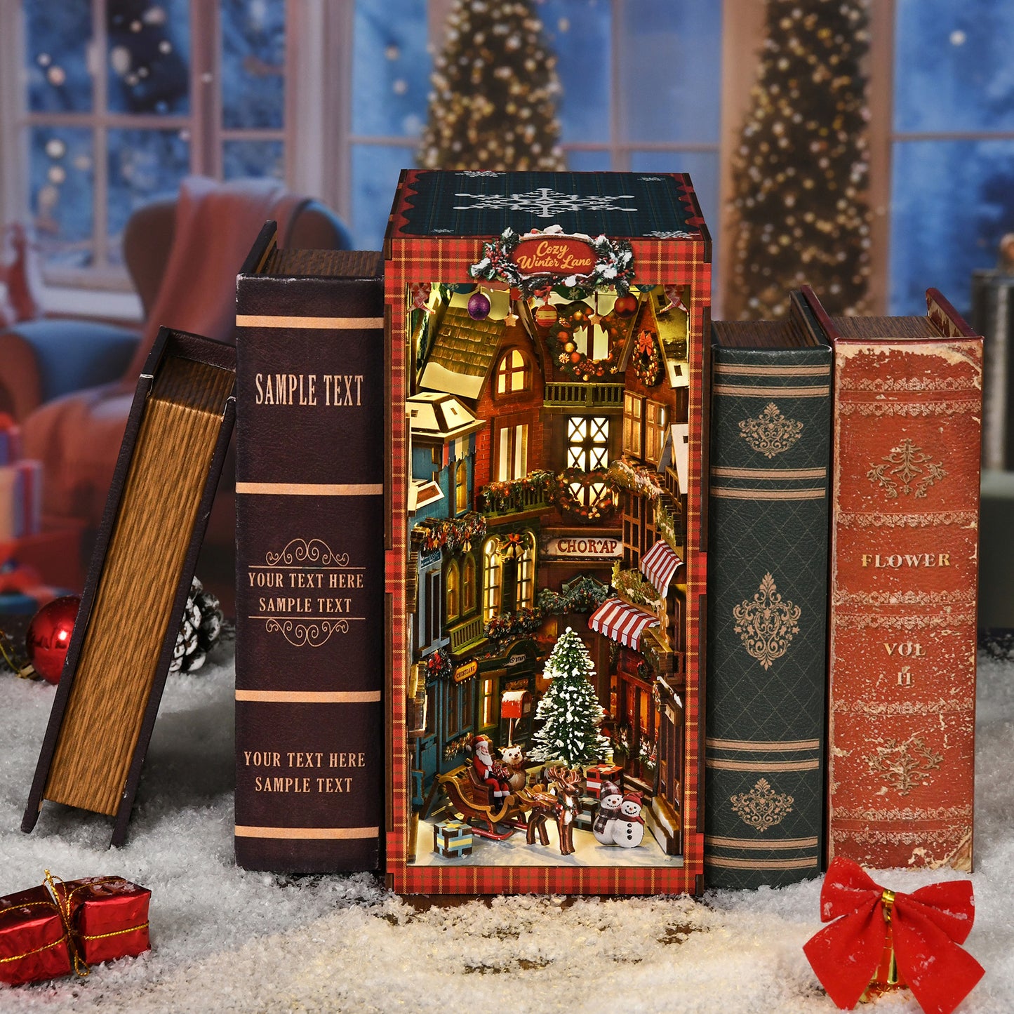 A miniature Christmas village scene is displayed on a shelf, surrounded by books and holiday decorations.