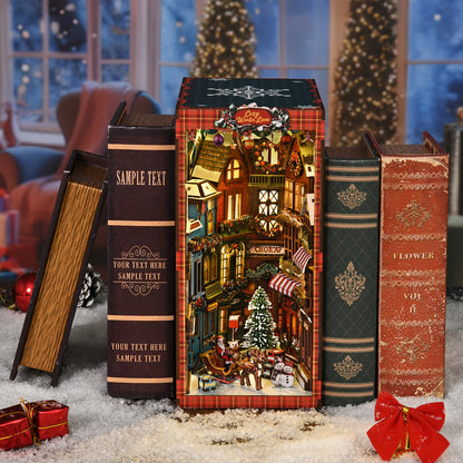 A miniature Christmas village scene is displayed on a shelf, surrounded by books and holiday decorations.