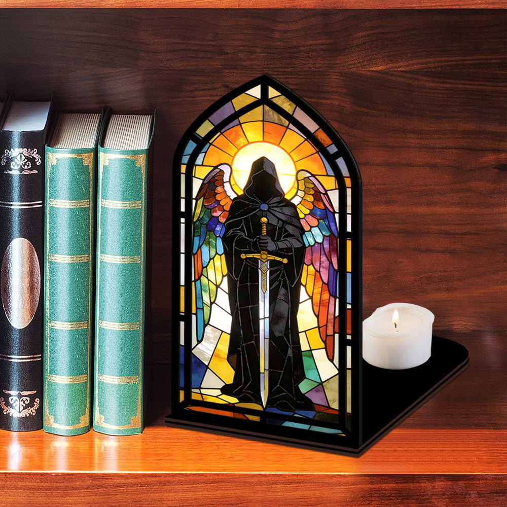 Stained-glass arched book nook display with hooded knight and lit candle on tabletop