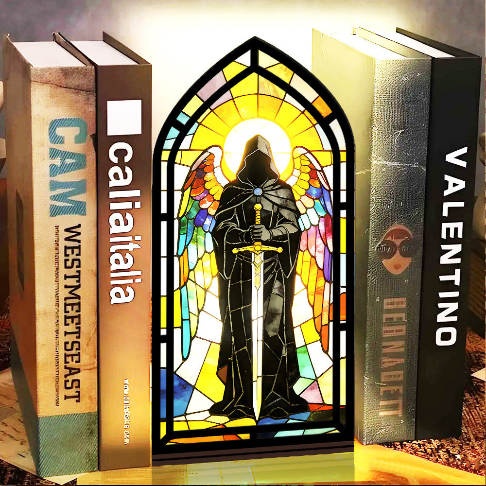 Stained-glass arched book nook display with hooded knight figure and black candle tray