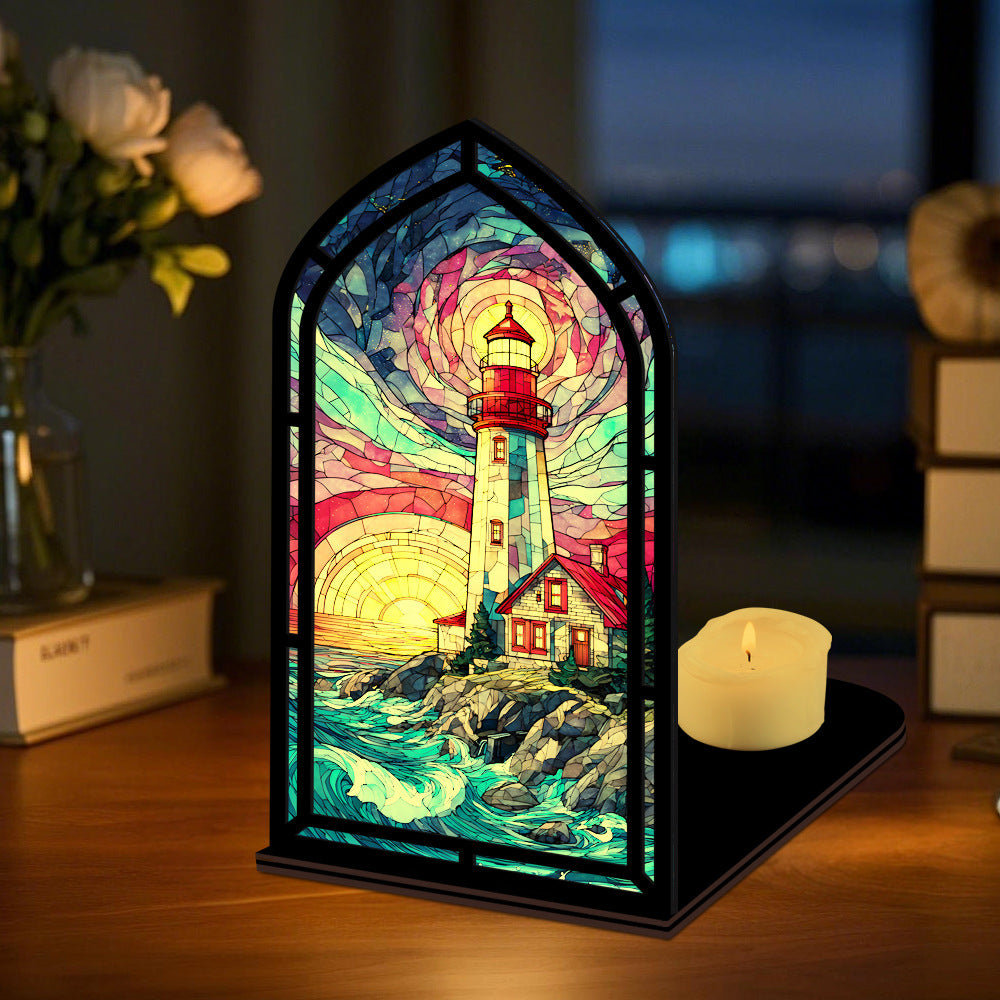Coastal lighthouse book nook on tabletop with stained-glass lighthouse and lit candle