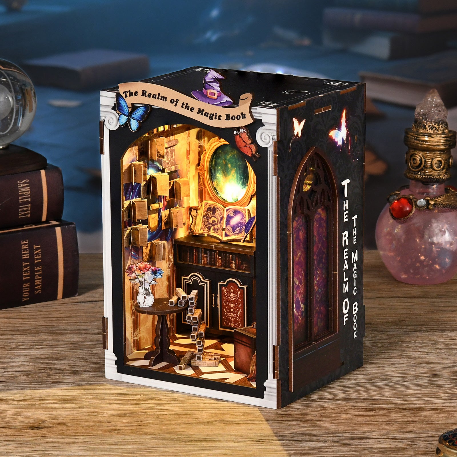 DIY miniature book nook kit on a table, dark cabinet with open interior scene