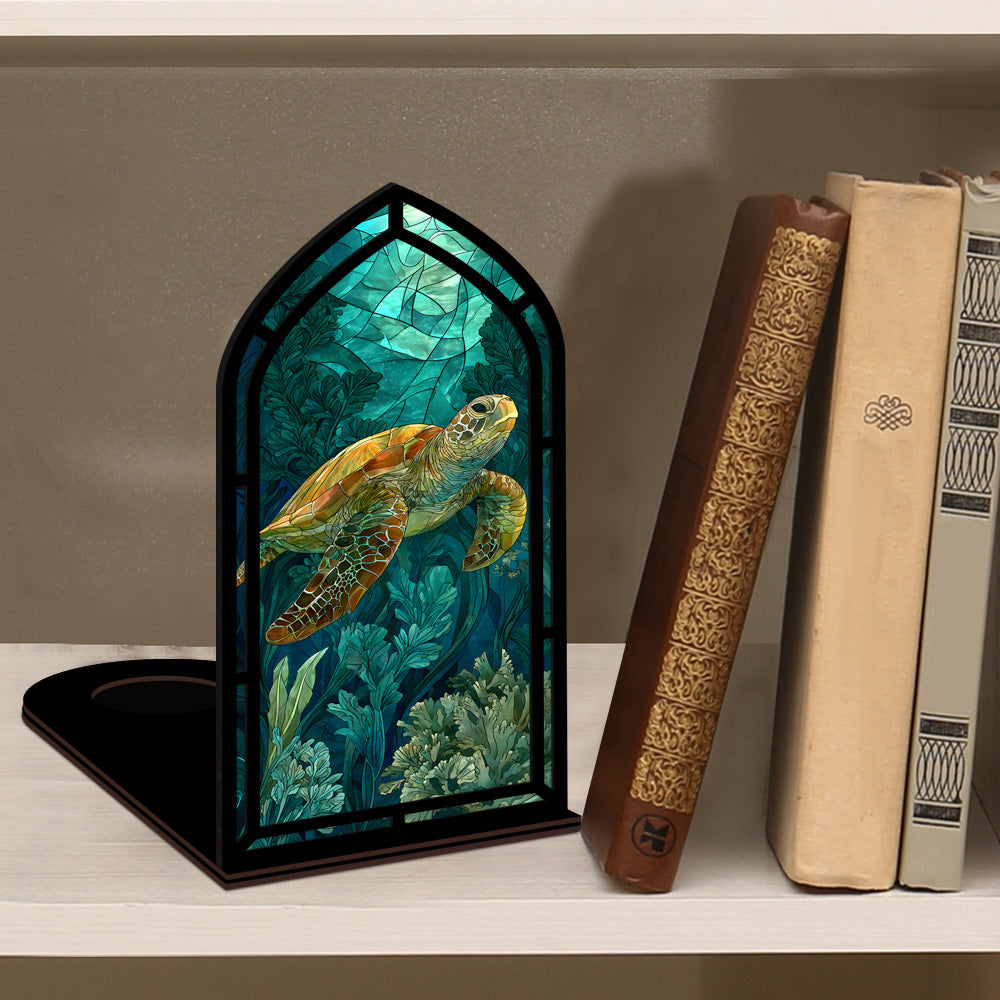Book nook display with sea turtle scene in black frame, placed on a shelf among books