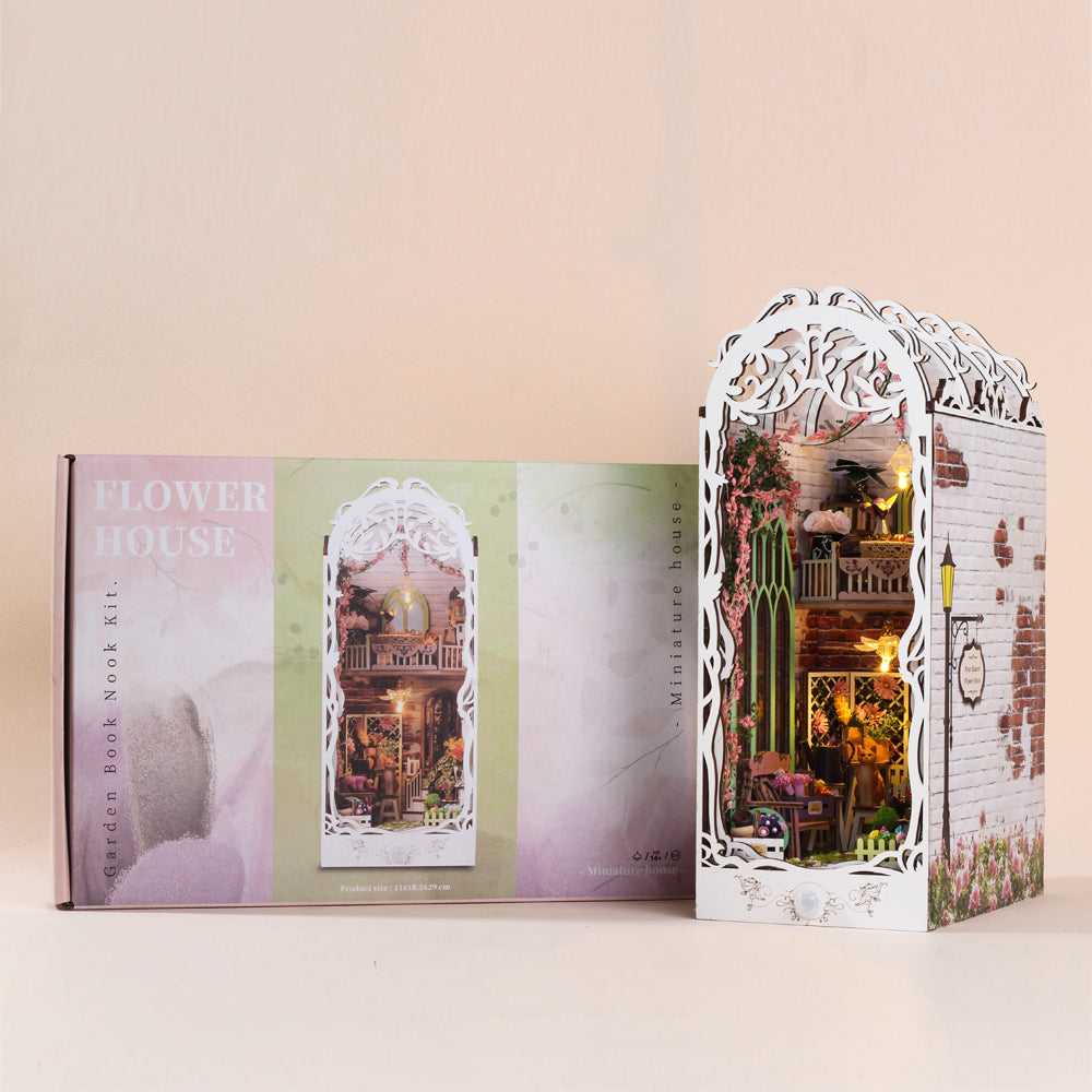 Miniature book nook kit in packaging with photo of white arched lit garden scene