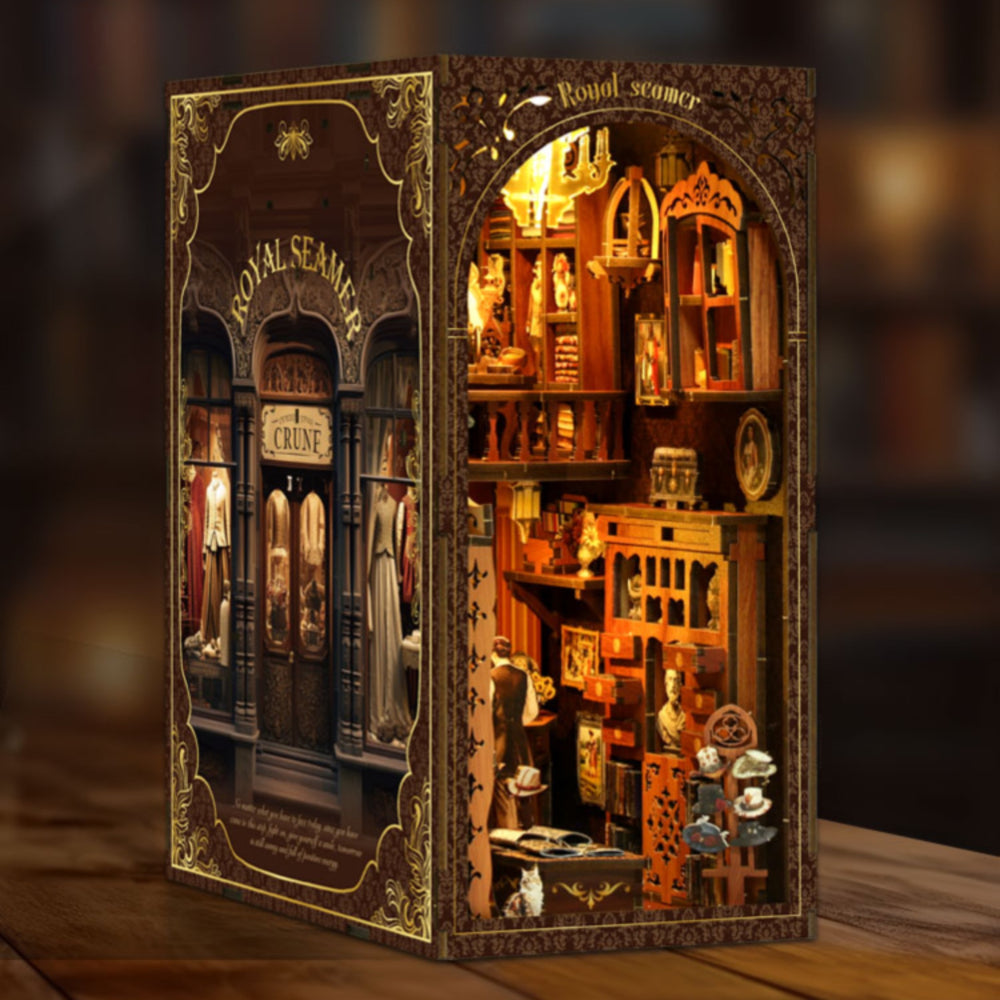 DIY book nook kit with glowing miniature room interior on a display stand