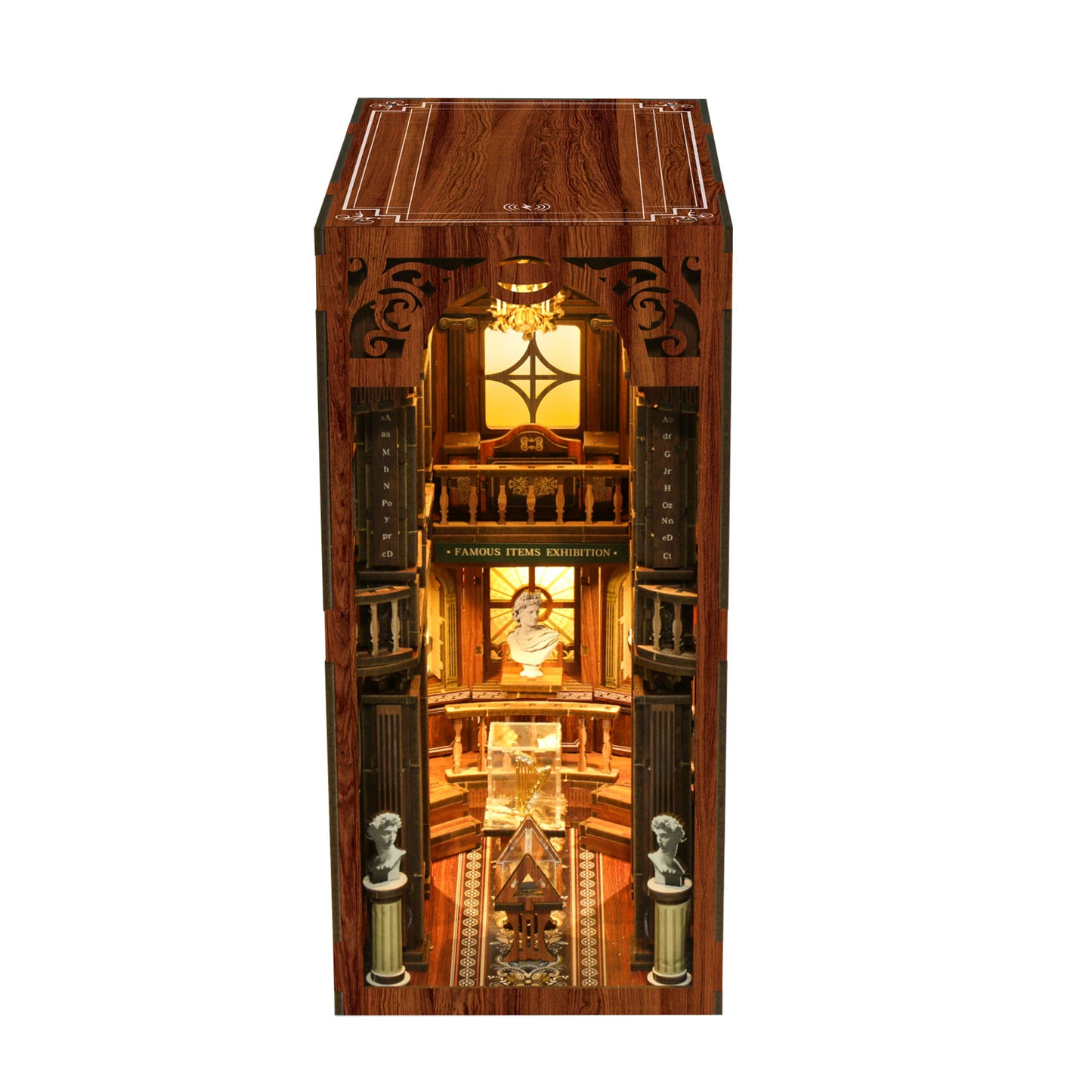 A wooden model of a building with intricate carvings and details, including a stained glass window and a chandelier.