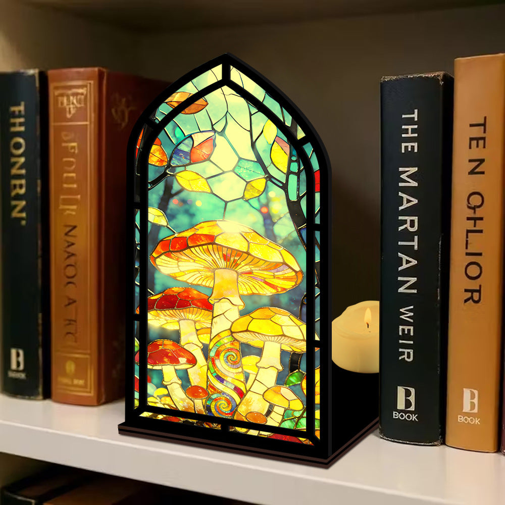 Mushroom stained-glass book nook with arched panel, mushroom scene, and lit candle on base