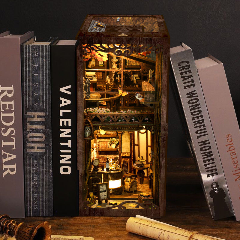 DIY book nook kit with miniature coffee house model shown beside book-shaped accessories