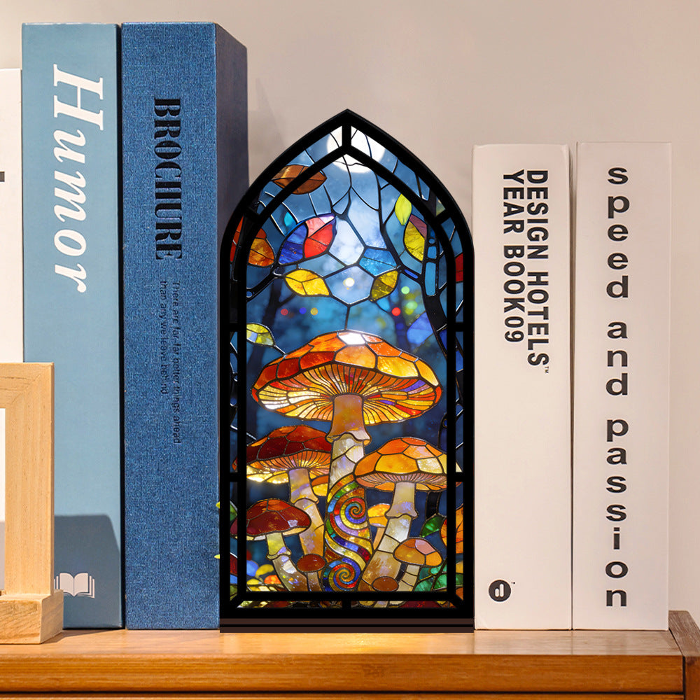 Mushroom stained-glass book nook with arched window panel and black frame on shelf
