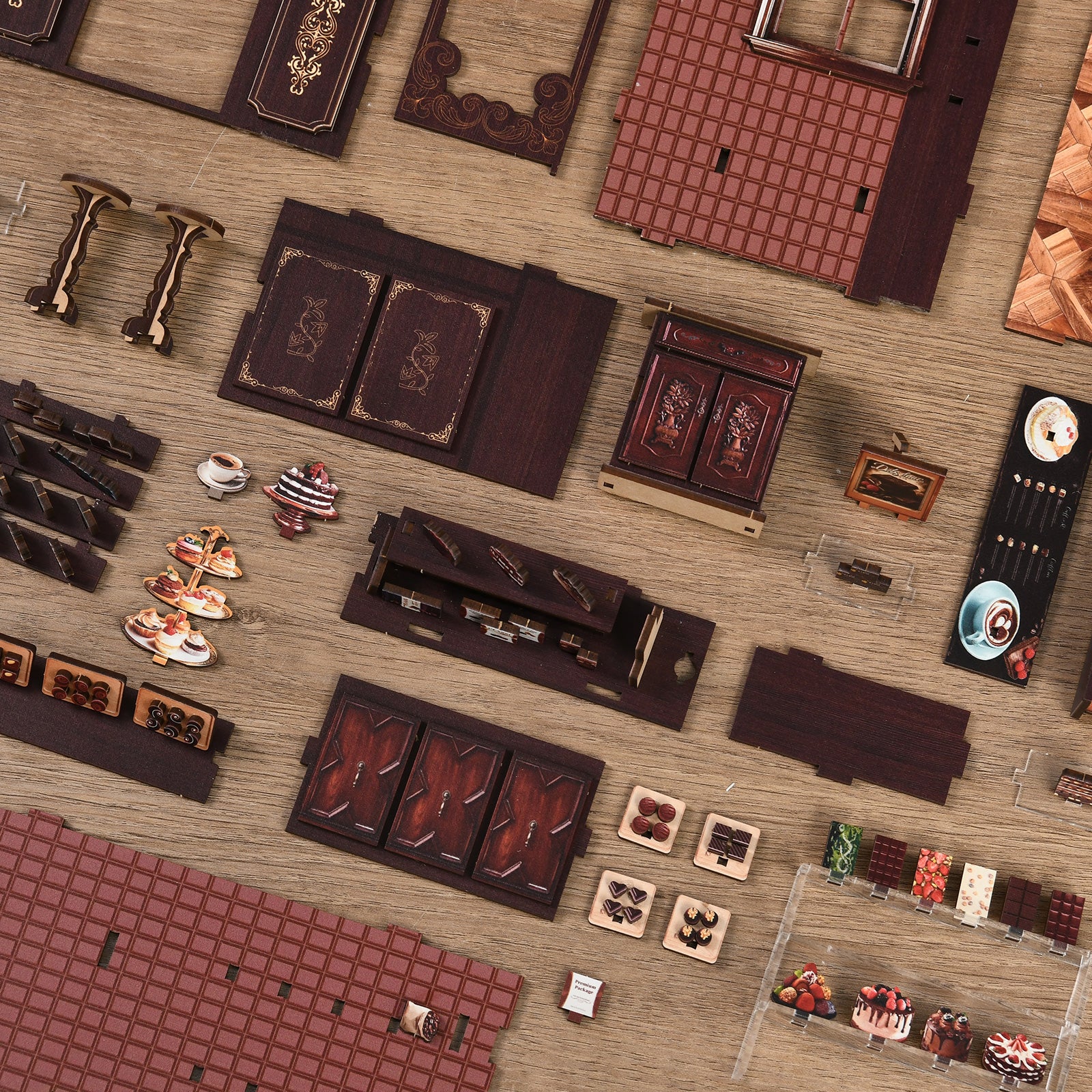 various wooden and metal objects, including a wooden cabinet, a wooden shelf, and a wooden box, arranged on a wooden surface.