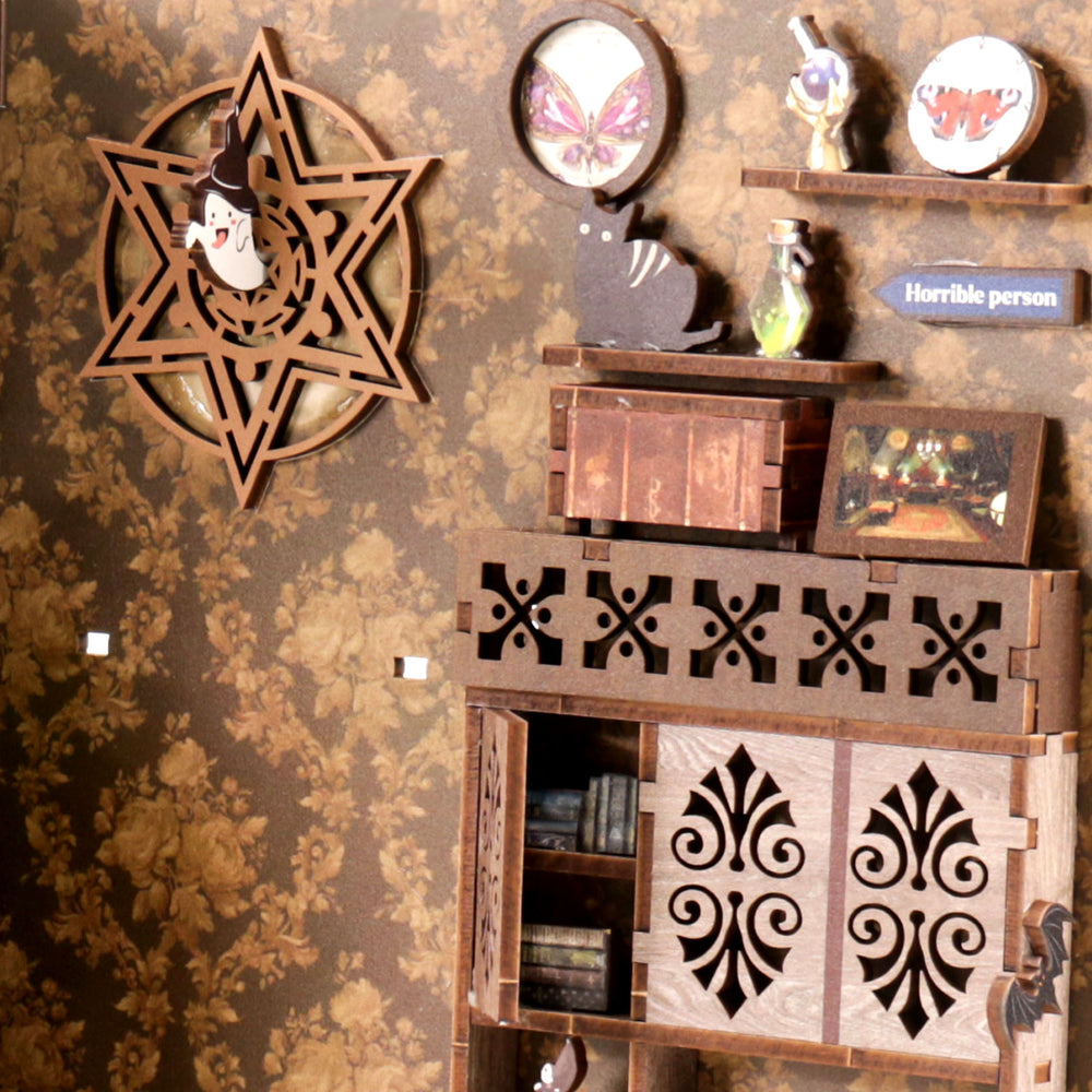Miniature book nook wall decor with star ornament, framed sign, and small shelf compartments