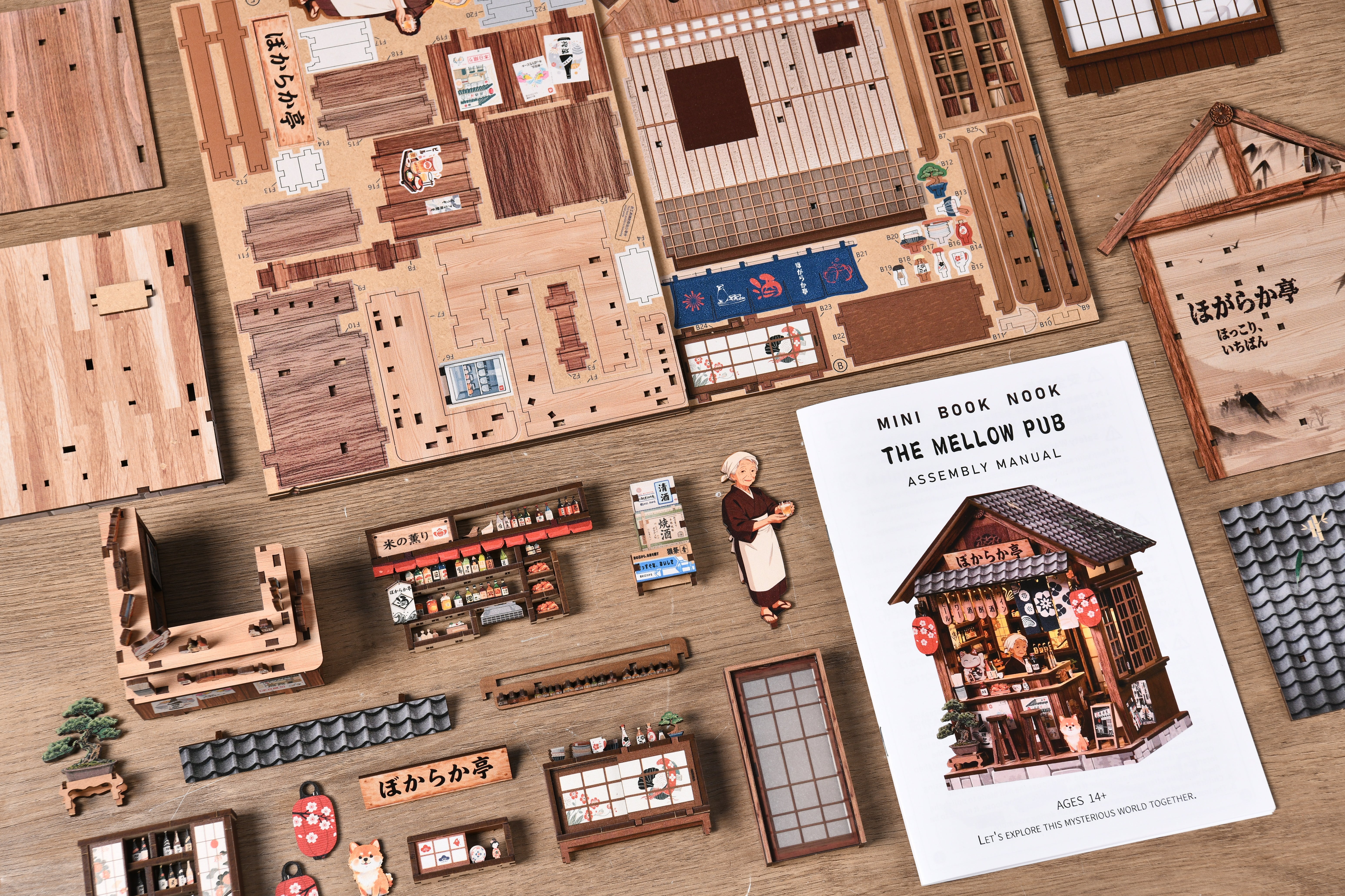 DIY mini book nook kit with mini pub model, parts pieces, and instruction booklet