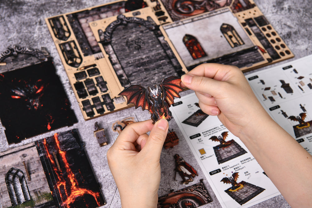 DIY booknook kit parts and dragon figurine, with instruction sheet in hand