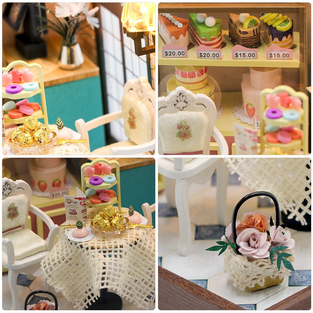 Miniature bakery diorama detail: tiny chairs, lace table, desserts and floral decor with light