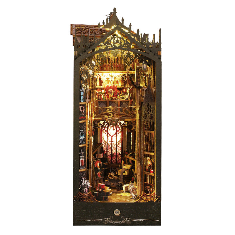 Miniature castle bookshelf display, ornate gold-lit interior with gothic arch details