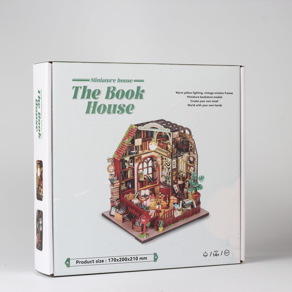 Miniature dollhouse kit box featuring The Book House design and a small model illustration