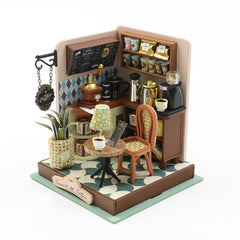 Mini coffee shop room box diorama kit with counter, mugs, cups, and lantern light