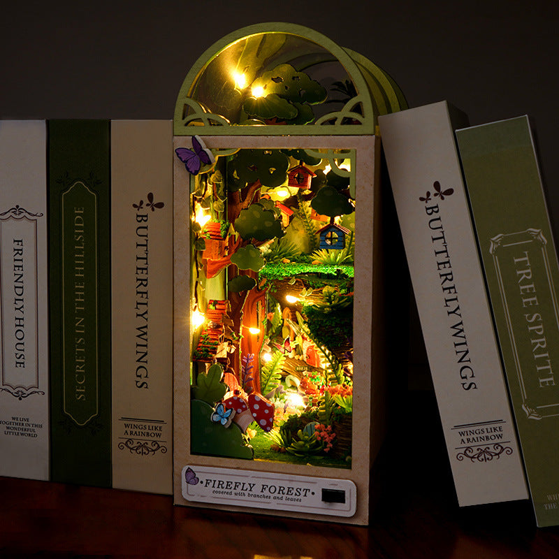 Illuminated woodland book nook kit in standing box with window frame, assembled scene