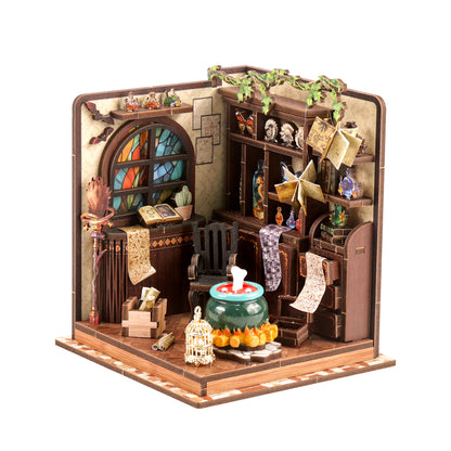 A detailed miniature diorama depicting a quaint, rustic room with various objects and decorations, including a stained glass window, a bookshelf, a birdcage, and a small table with a vase and other items.