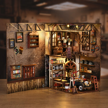 A detailed miniature model of a workshop or garage, featuring various tools, equipment, and decorative elements such as shelves, a clock, and a car.