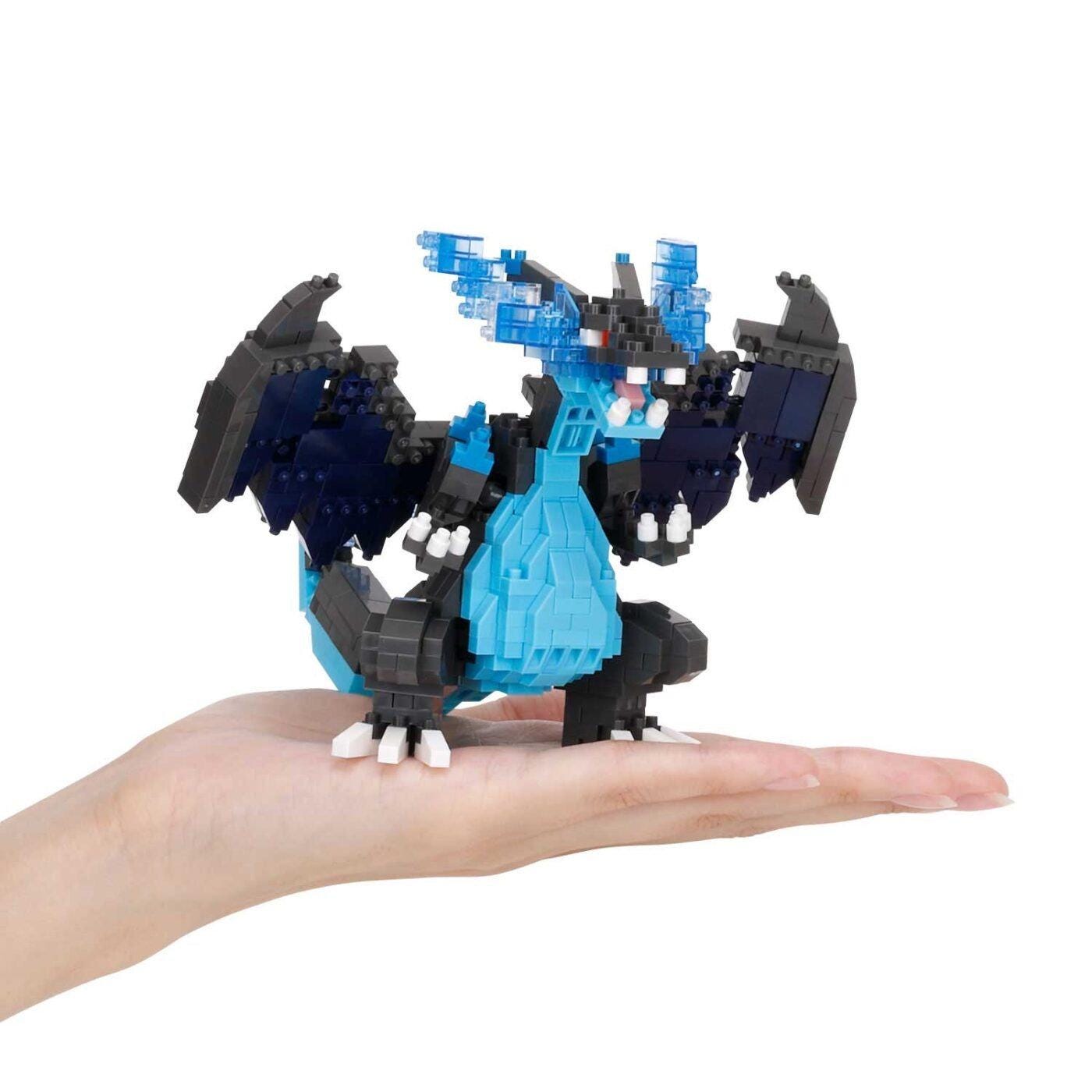 Assembled nano building block dragon figure in blue and black, held on an open hand