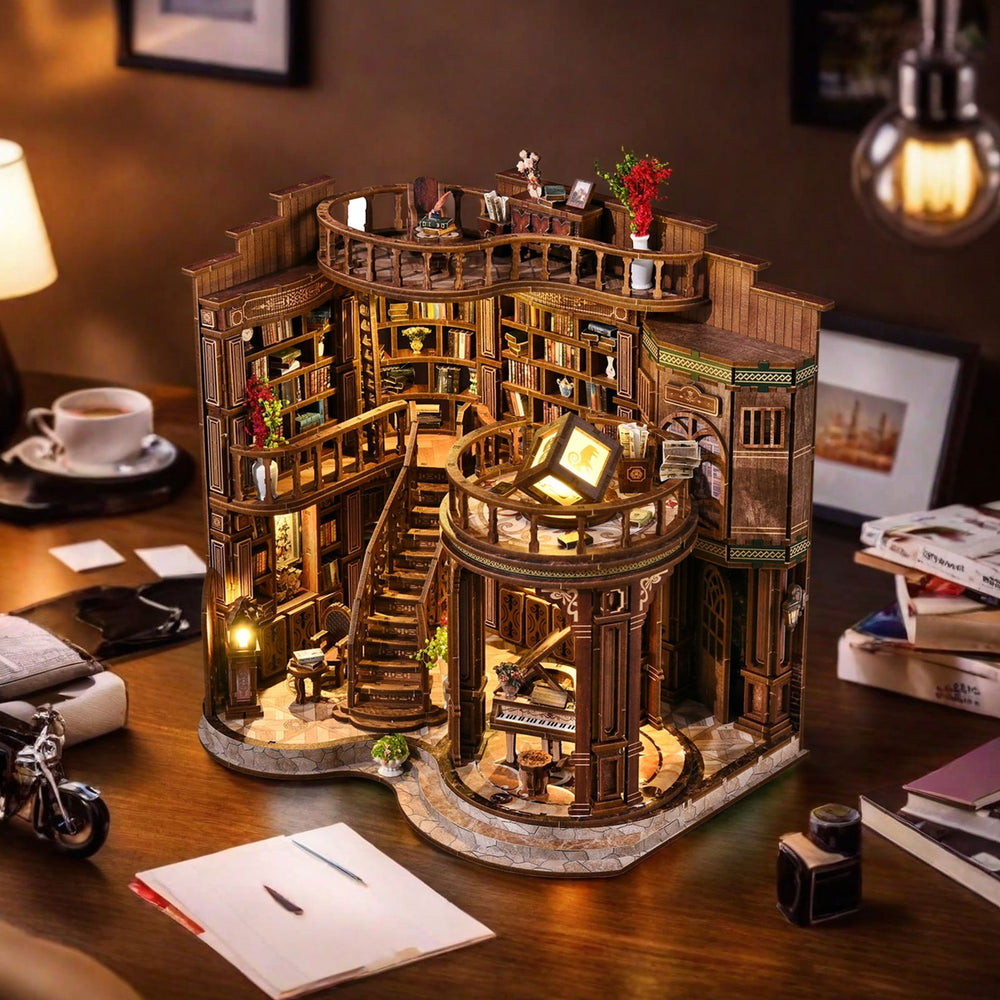 Miniature library hall dollhouse with spiral stairs, glowing desk lamp, and book shelves