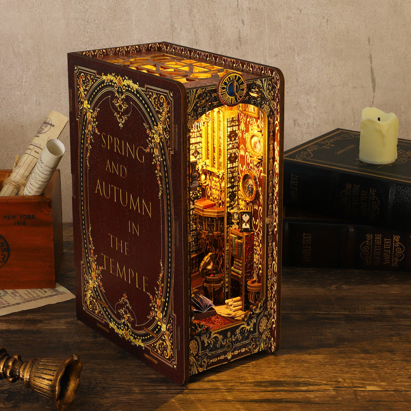 Gothic book nook kit with lit church scene and 'Spring and autumn' spine text
