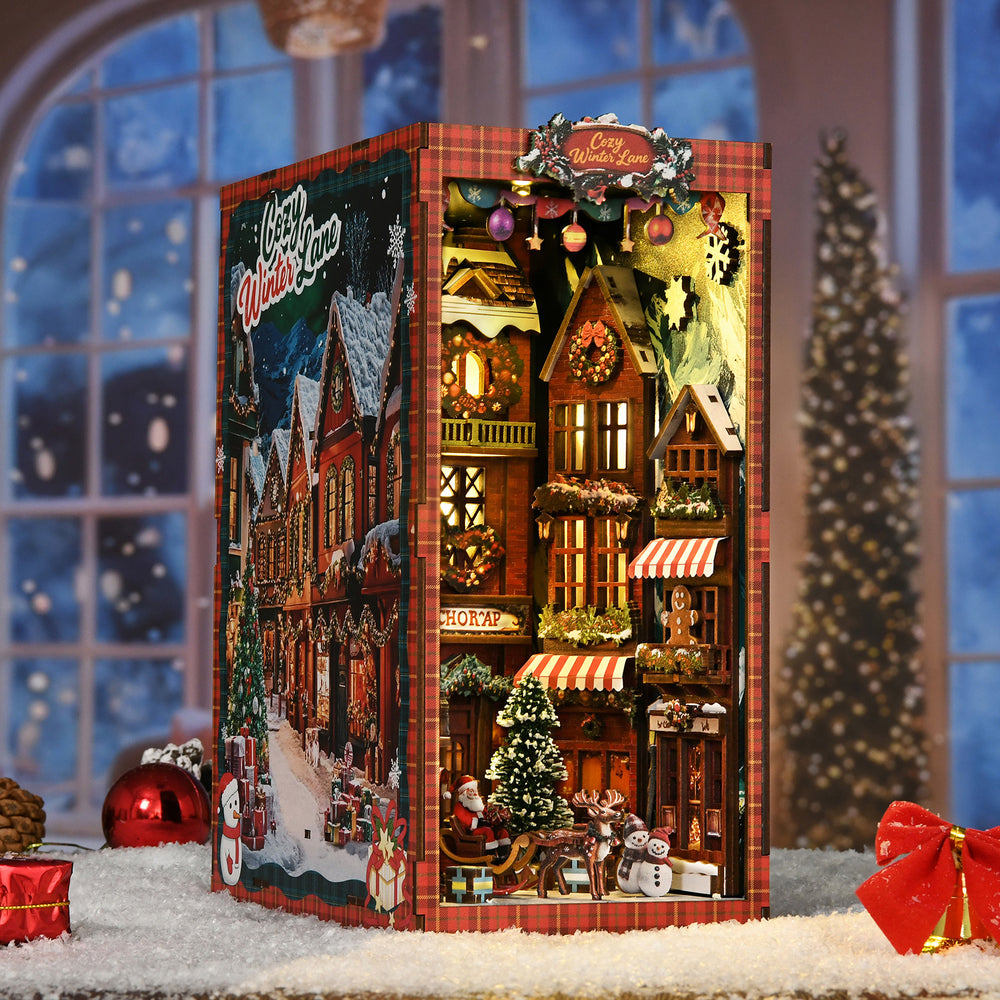 DIY book nook kit box featuring a lit Christmas street corner miniature storefront scene