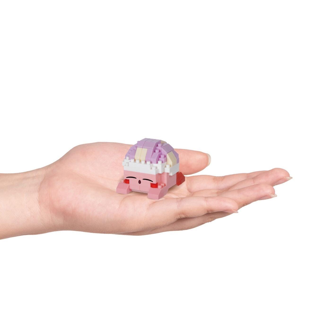 Nano building blocks Kirby Sleep figure held in hands, pink, purple, and white