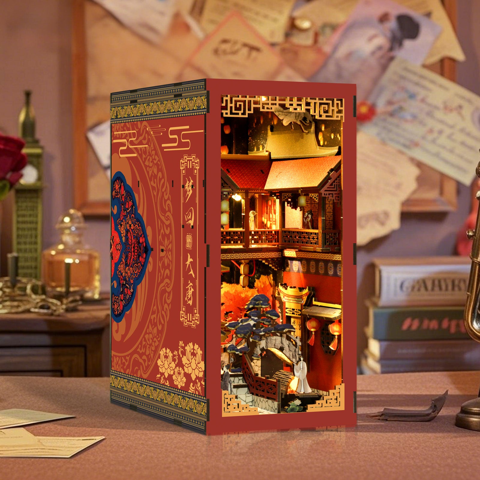 DIY book nook kit box standing on tabletop, red and gold Tang-style interior scene artwork