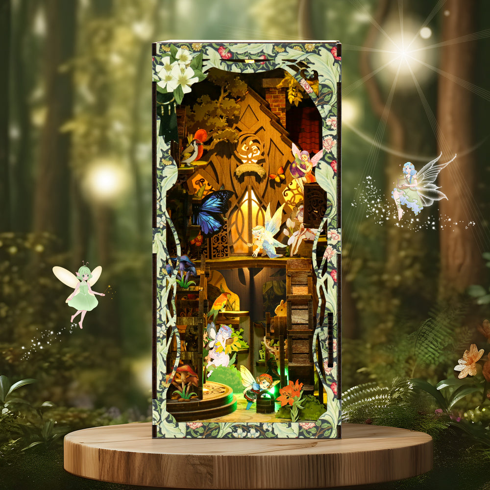 DIY book nook kit box on round wooden platform with forest scene and glowing figures