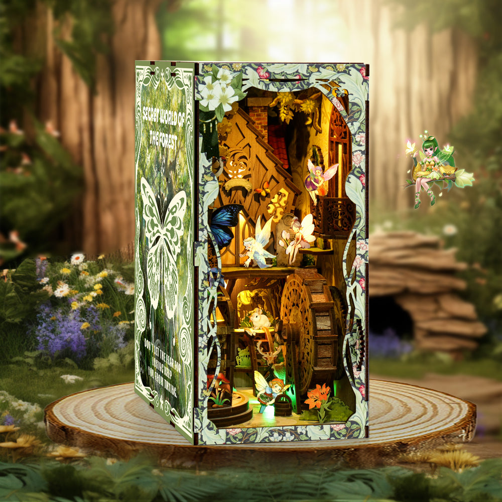 DIY book nook kit box standing upright on a wooden base with forest scene display window