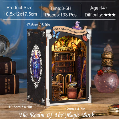 a miniature diorama of a fantasy-themed room, including a bookshelf, a fireplace, and a crystal ball. The diorama is set against a blue background, and there are books and a crystal ball visible in the scene.