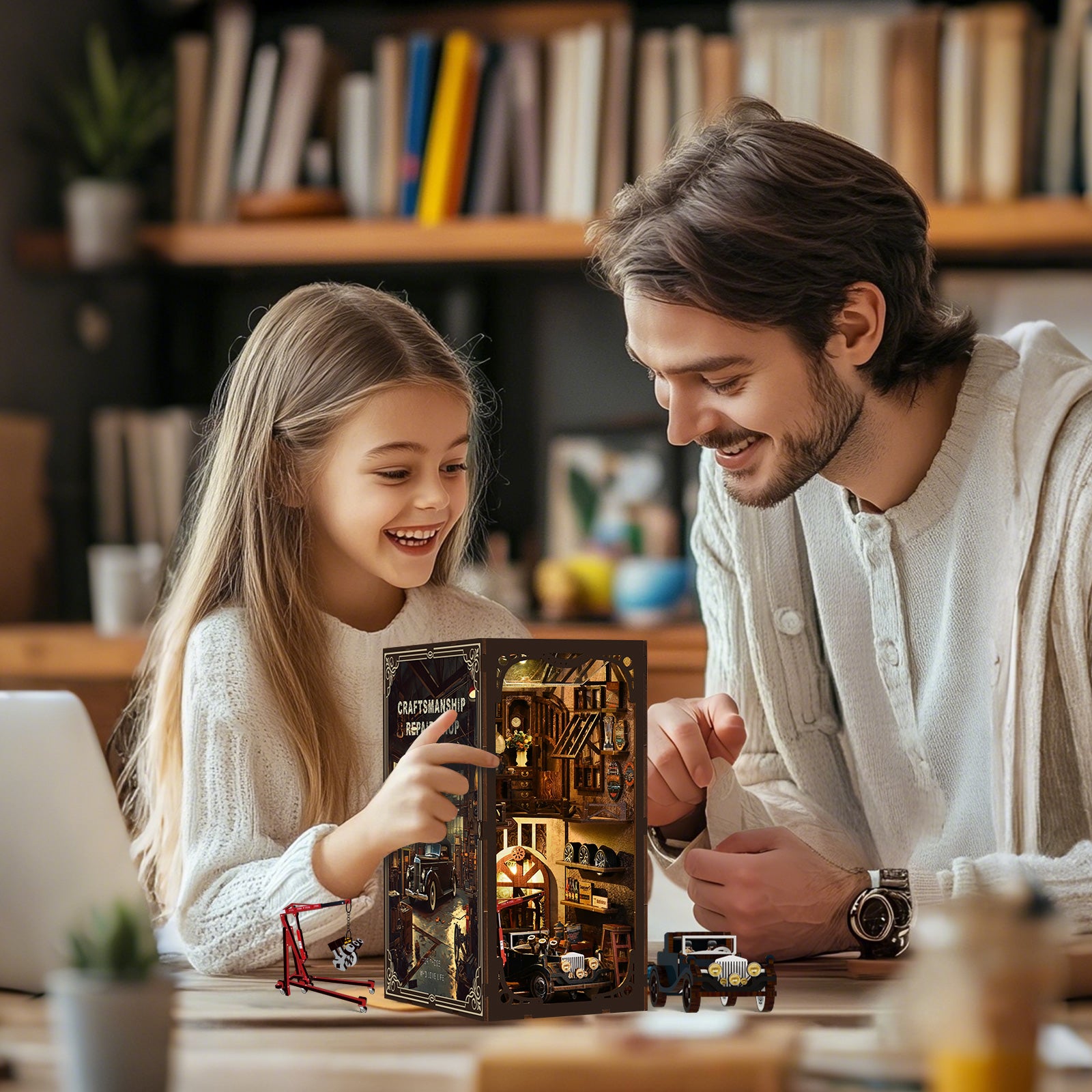 A young girl and a man are smiling and looking at a small, intricately designed model house together.