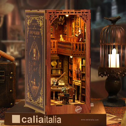 A miniature wooden dollhouse with a detailed interior, including a balcony, bookshelves, and a lamp, displayed on a wooden stand.