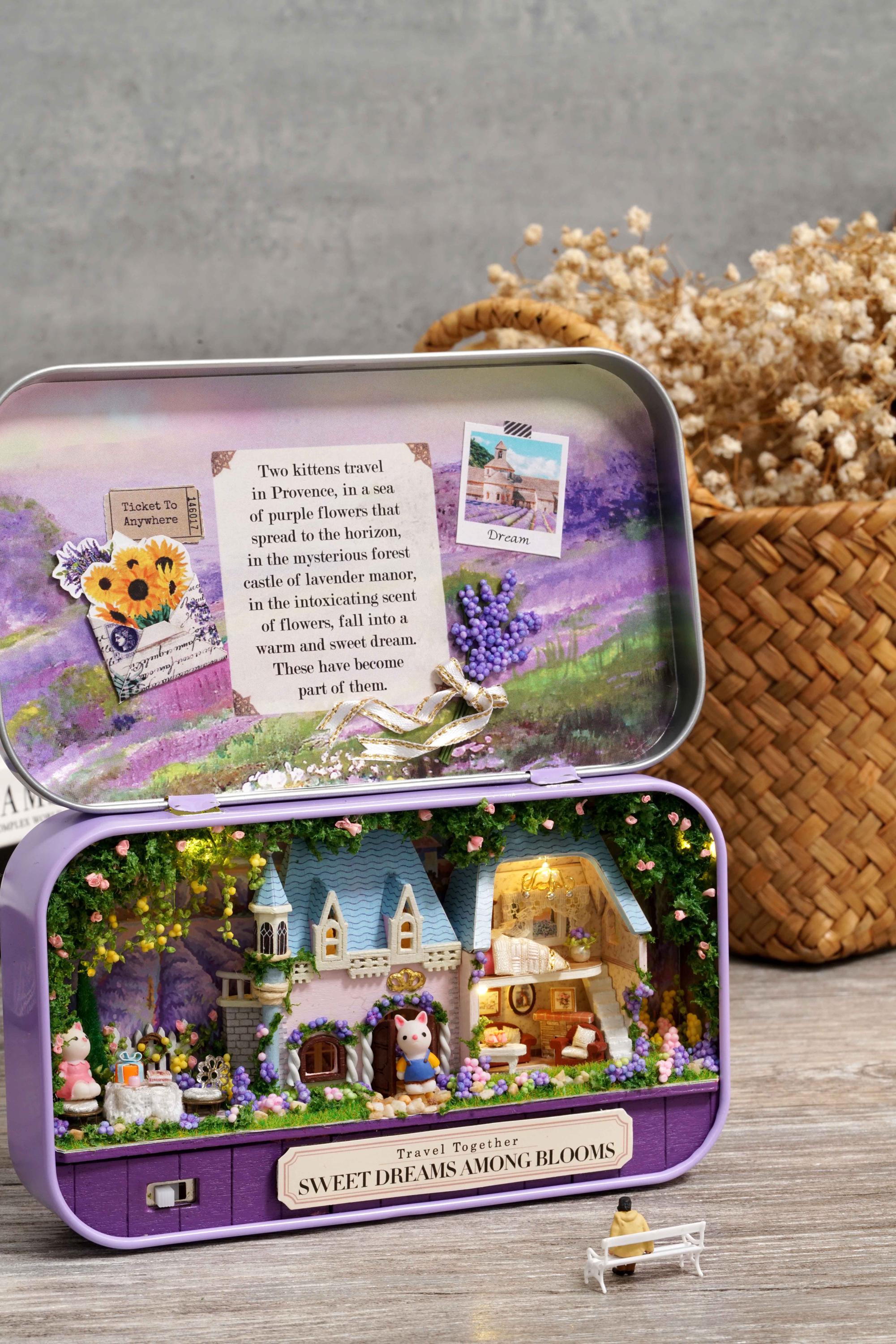 Purple travel tin box theater closed with flower illustration on lid and small bow