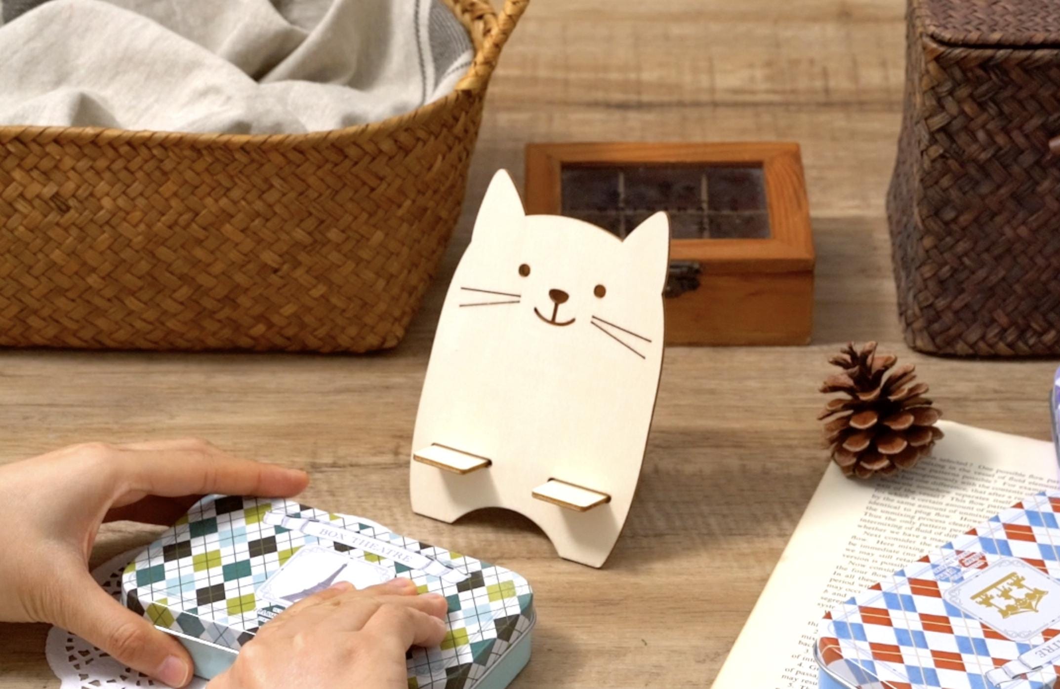 Cat-shaped cardboard organizer box with small compartments and craft pieces on table