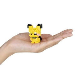 A hand holding a small yellow pixelated character, likely a pixelated Pokémon, against a white background.
